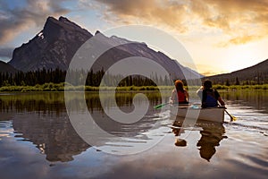 Couple adventurous friends are canoeing in a lake