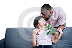 Couple, African American husband gives roses flower and kissing his wife with love