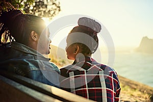 Couple of African descent sitting on a public viewpoint bench