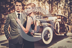 Couple against vintage car