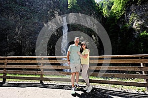 Couple against waterfall in Liechtensteinklamm or Liechtenstein Gorge, Austria