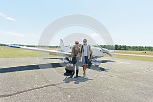 couple at airfield walking away from light aircraft