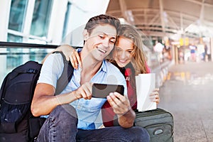 Couple in airport using travel app