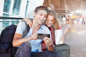Couple in airport using travel app photo