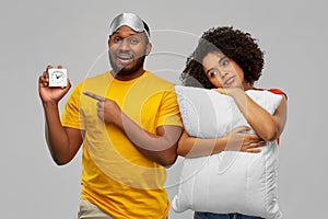 Couple with alarm clock, sleeping mask and pillow