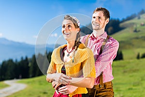 Couple on Alp mountain summit at vacation