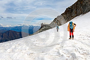 Couple alpinists mountaineers walking glacier  slopes. Mont Blanc