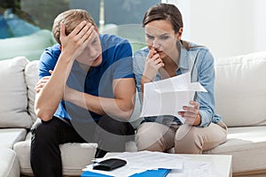 Couple analyzing family bills photo