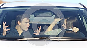 Couple arguing while she is driving a car photo