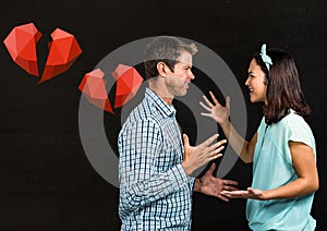 Couple arguing with each other against black background