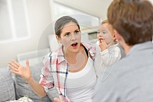 Couple arguing in fornt of their baby