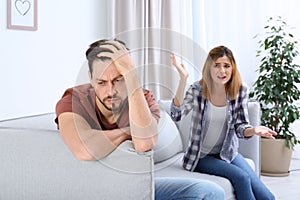 Couple arguing in living room.