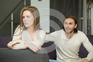 Couple arguing, offended affronted woman ignoring man shouting a