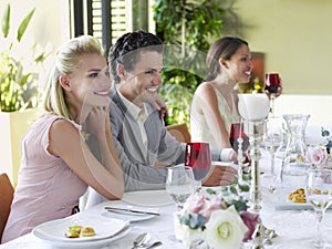 Couple With Arm Around At Dinner Party