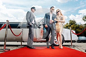 Couple arriving with limousine walking red carpet