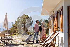 Couple arriving to at holiday home