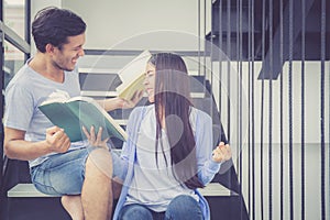 Couple asian handsome man and beautiful woman reading book and glad at home.