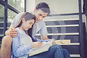 Couple asian handsome man and beautiful woman reading book and smile