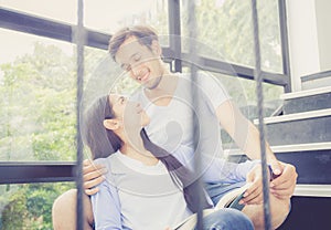 Couple asian handsome man and beautiful woman reading book and smile at home.