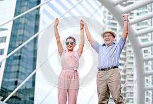 Couple of Asian old man and woman tourist are acting as exciting and very happy. This photo also contain concept of good life of