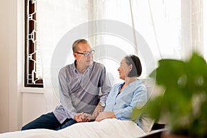 Couple asian senior encourage and hugging on bed together,Happy and smiling,Positive thinking