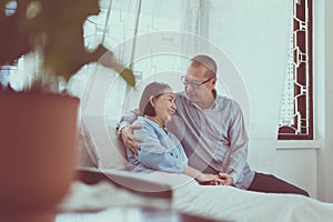 Couple asian senior encourage and hugging on bed together,Happy and smiling,Positive thinking