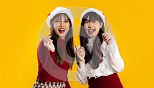 A couple of asian women in red and white color costume for celebrate Christmas and new year party