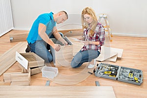 Couple Assembling Wooden Drawers