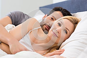 Couple awake on bed
