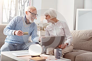 Couple of baby boomers vigorously discussing purchasing online