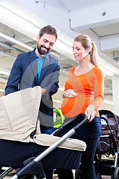 Couple in baby shop buying stroller