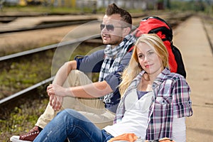 Couple backpack traveling resting on railroad trip