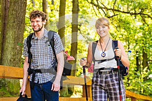 Couple backpacker hiking in forest pathway