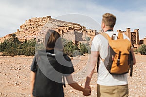 Couple of backpacker travelers on background Ait Ben Haddou ksar in Ouarzazate