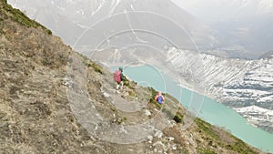 Couple backpackers do acclimatization near lake Birendra in Nepal. Manaslu area.