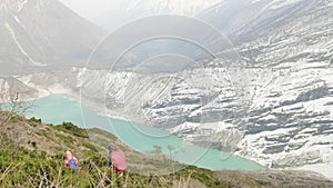 Couple backpackers do acclimatization near lake Birendra in Nepal. Manaslu area.