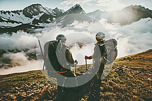 Couple backpackers enjoying mountains clouds view