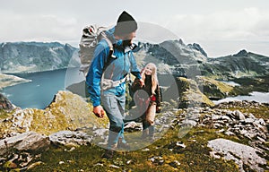 Couple backpackers hiking in Norway mountains