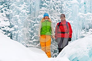 Couple backpackers and ice waterfall
