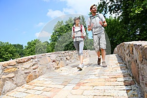 Couple of backpackers walking on bridge