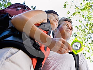 Couple with backpacks and compass