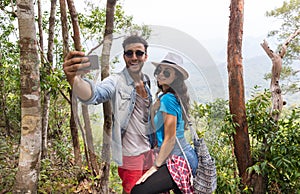 Couple With Backpacks Take Selfie Photo Over Mountain Landscape Trekking, Young Man And Woman On Hike Tourists