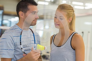 couple with badminton rackets