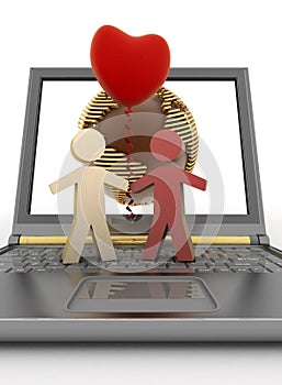 Couple with a balloon in form of heart on laptop