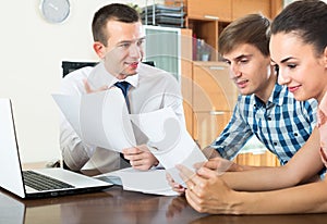 Couple and banking agent discussing