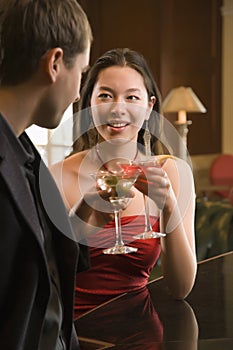 Couple at bar with drinks.