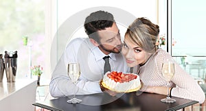 Couple at the bar with sparkling wine and cake, love conce