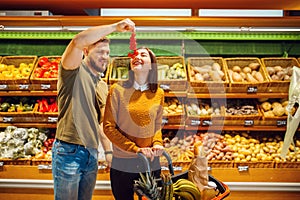 Couple with basket in grocery supermarket together