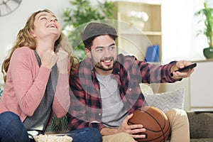 couple basketball supporter watching television photo
