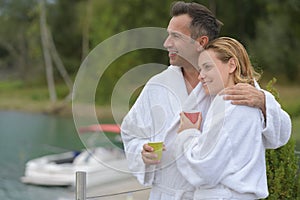 Couple in bathrobe sitting on pontoon